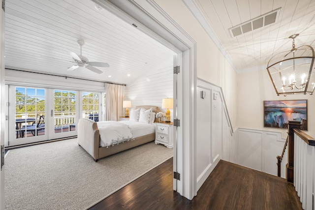 bedroom with ceiling fan with notable chandelier, dark hardwood / wood-style floors, access to exterior, and ornamental molding