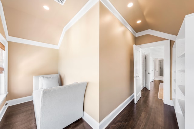 hallway with ornamental molding, dark wood-type flooring, and lofted ceiling