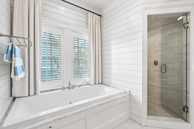 bathroom featuring plenty of natural light, tile flooring, and plus walk in shower