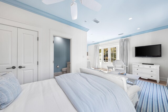 bedroom featuring hardwood / wood-style flooring, crown molding, connected bathroom, and ceiling fan