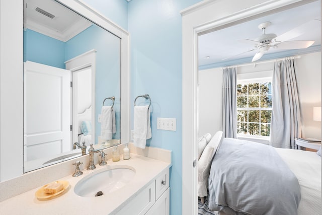 bathroom with ceiling fan, vanity, and ornamental molding