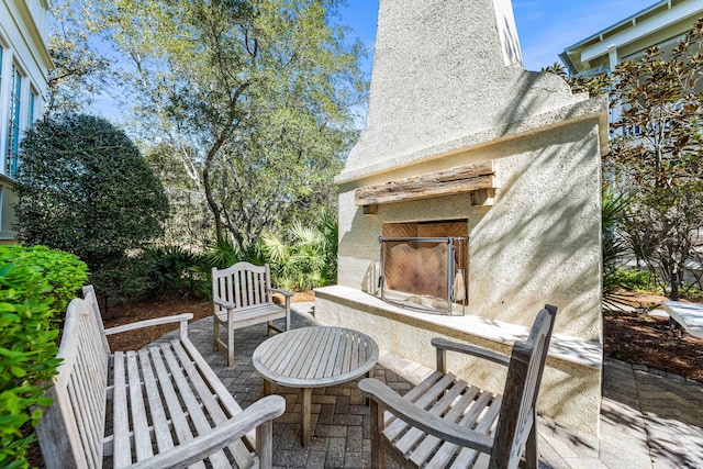 view of patio / terrace with exterior fireplace