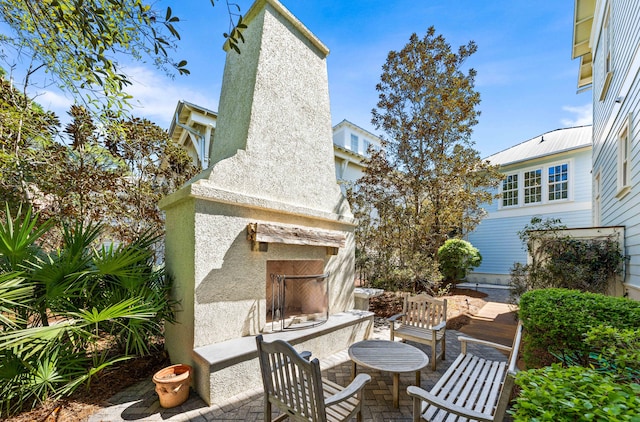 view of patio with an outdoor fireplace