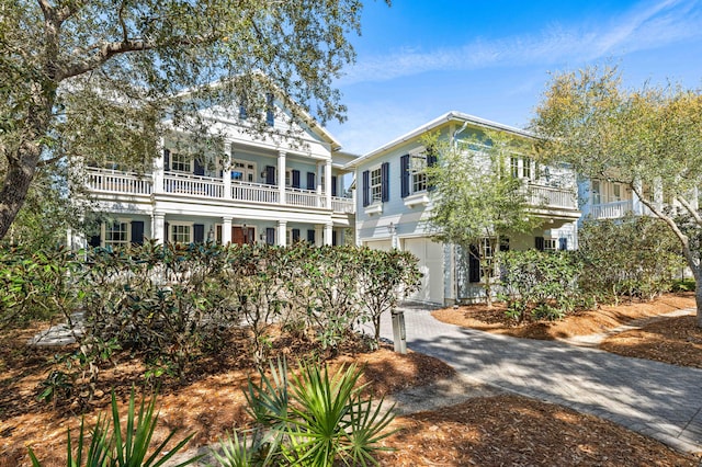 view of front of house with a garage and a balcony