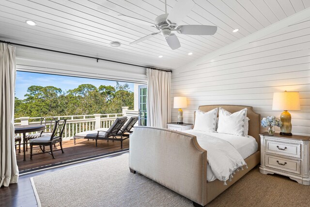 bedroom with dark hardwood / wood-style flooring, multiple windows, ceiling fan, and vaulted ceiling