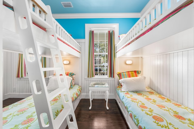 bedroom featuring ornamental molding and dark wood-type flooring