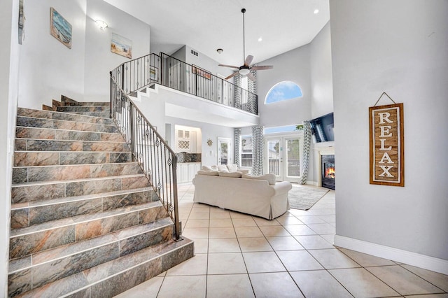 interior space with ceiling fan and a high ceiling