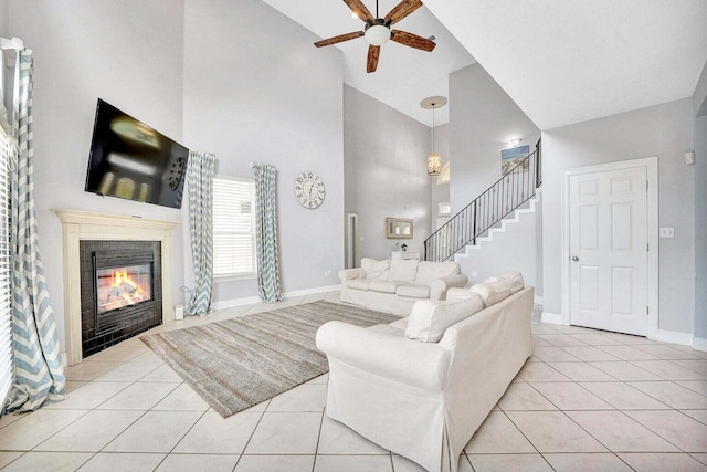 living room featuring high vaulted ceiling, ceiling fan, and light tile flooring