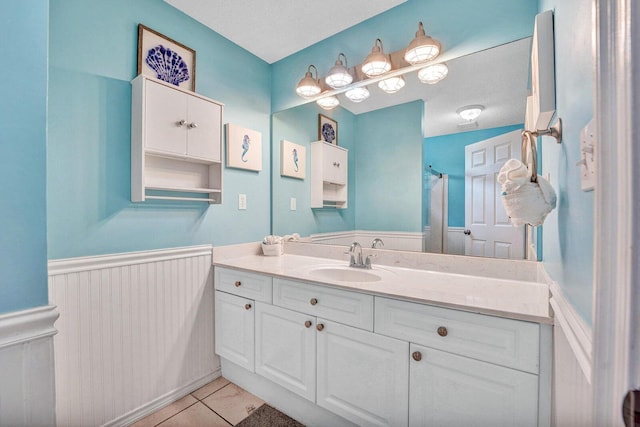 bathroom featuring tile flooring and vanity