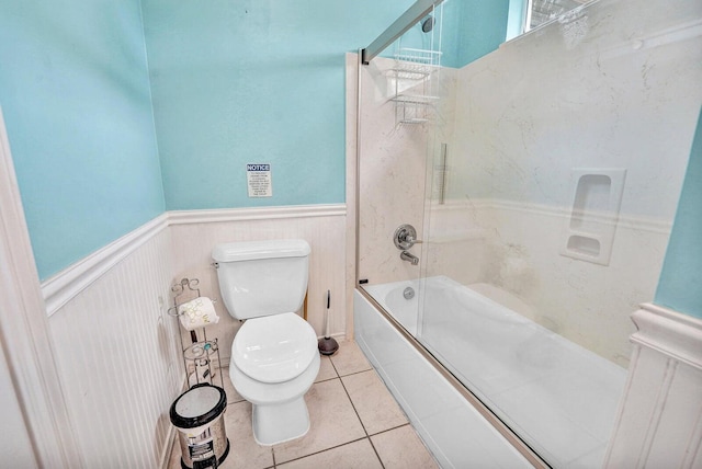 bathroom featuring tile flooring, shower / bathing tub combination, and toilet