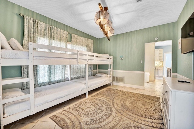 tiled bedroom with a textured ceiling