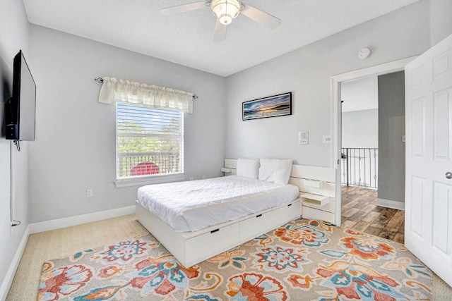 bedroom featuring light carpet and ceiling fan