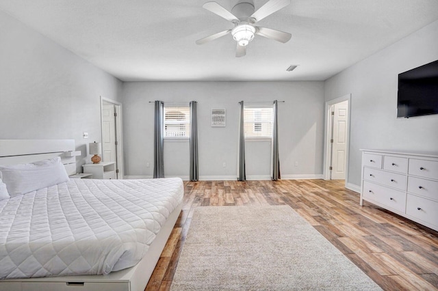 bedroom with light hardwood / wood-style flooring and ceiling fan