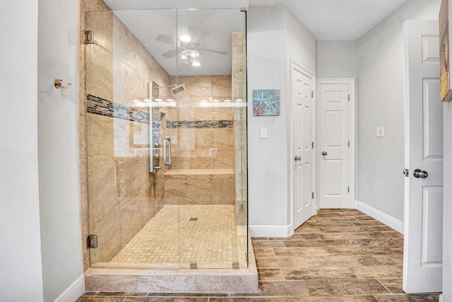 bathroom with hardwood / wood-style floors, walk in shower, and ceiling fan