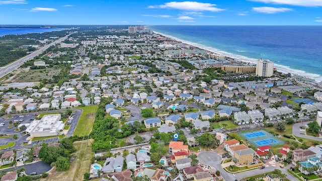 aerial view with a water view and a beach view