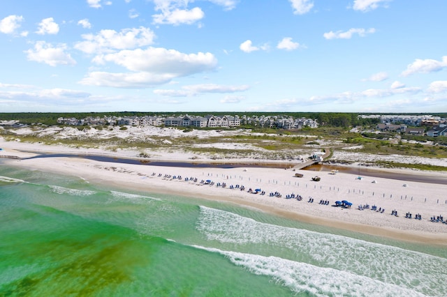 birds eye view of property featuring a water view and a beach view