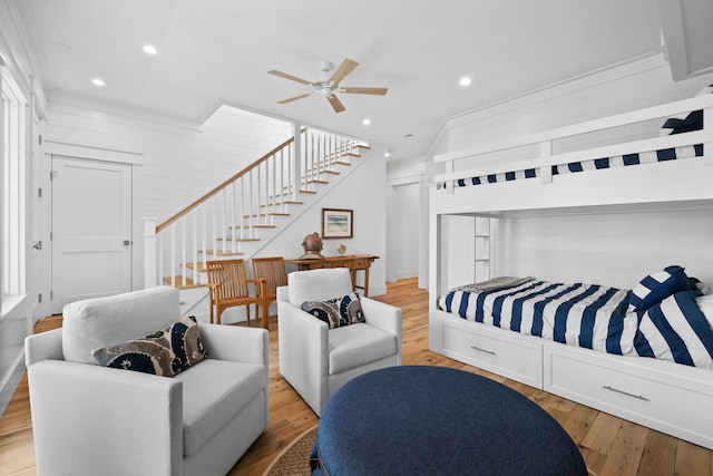 bedroom with light hardwood / wood-style flooring, ceiling fan, and multiple windows