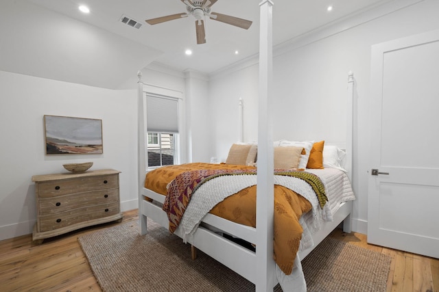 bedroom with ornamental molding, ceiling fan, and light wood-type flooring