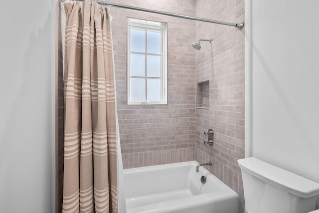 bathroom featuring shower / tub combo with curtain and toilet