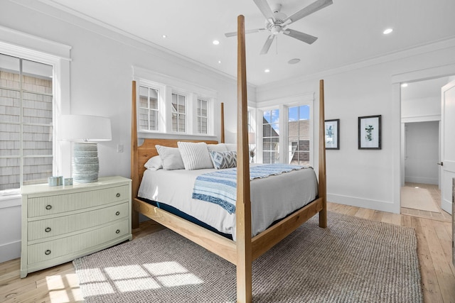 bedroom with light hardwood / wood-style floors, crown molding, and ceiling fan