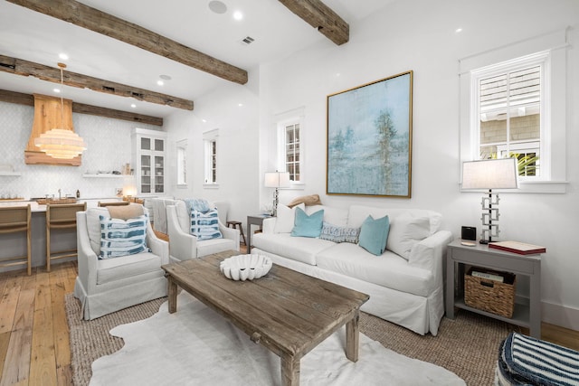 living room with beamed ceiling and hardwood / wood-style flooring