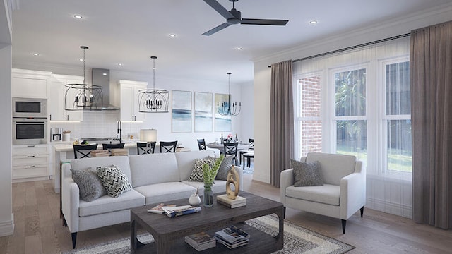 living room with light hardwood / wood-style floors, ceiling fan with notable chandelier, and ornamental molding