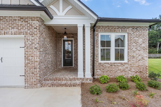 entrance to property with a garage and a porch