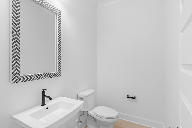 bathroom featuring hardwood / wood-style flooring, sink, and toilet