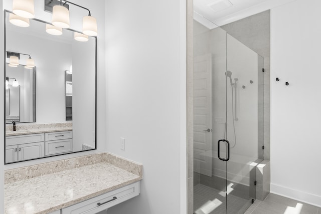 bathroom featuring tile patterned floors, vanity, a shower with door, and crown molding