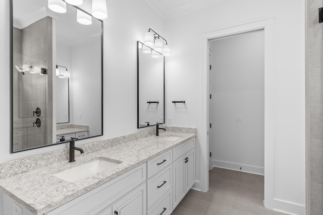 bathroom featuring a shower with shower door, vanity, tile patterned floors, and crown molding