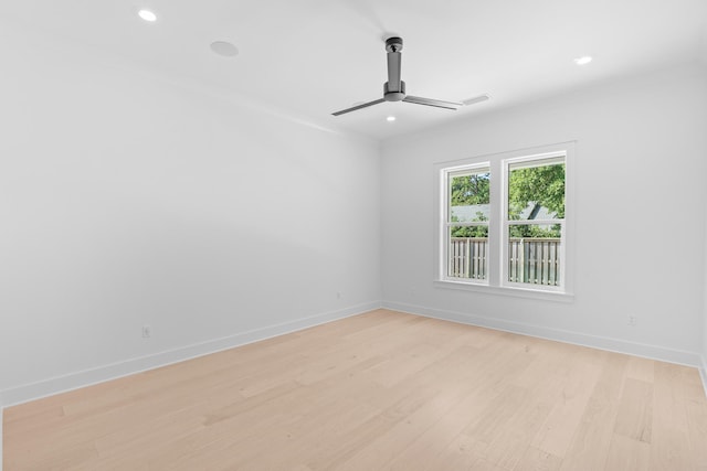 spare room featuring light wood-type flooring and ceiling fan