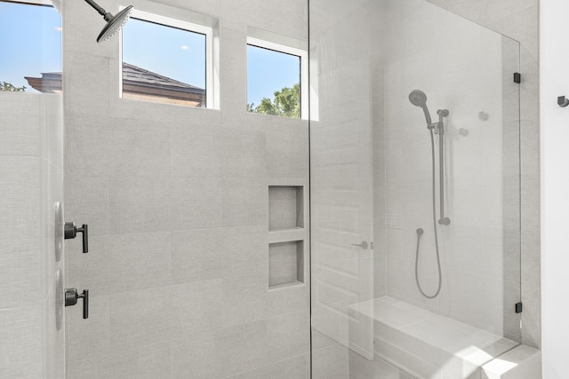 bathroom with a tile shower