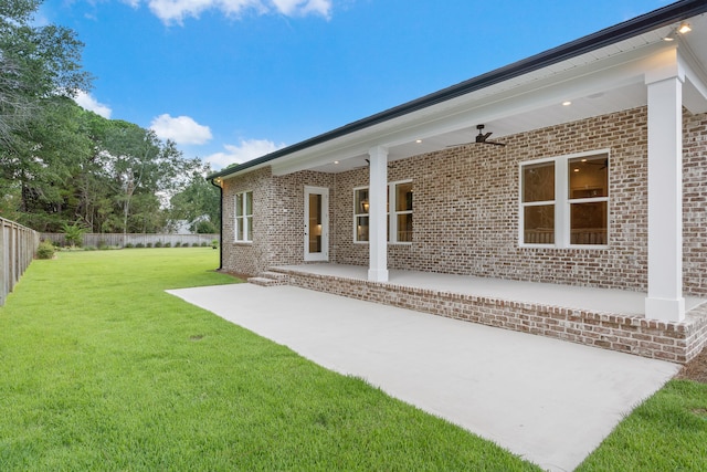 rear view of property with a lawn and a patio