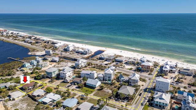 bird's eye view featuring a water view and a beach view