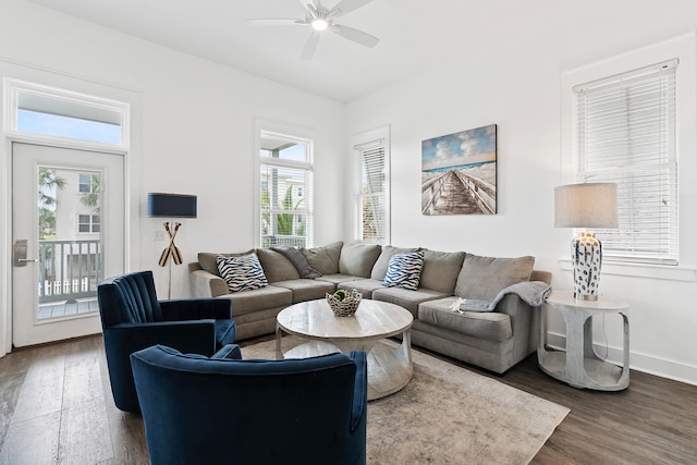 living room with dark hardwood / wood-style floors, a wealth of natural light, and ceiling fan