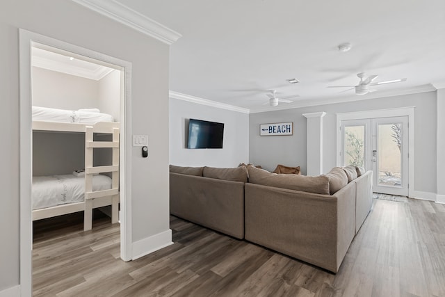 living room with crown molding, french doors, ceiling fan, and hardwood / wood-style flooring