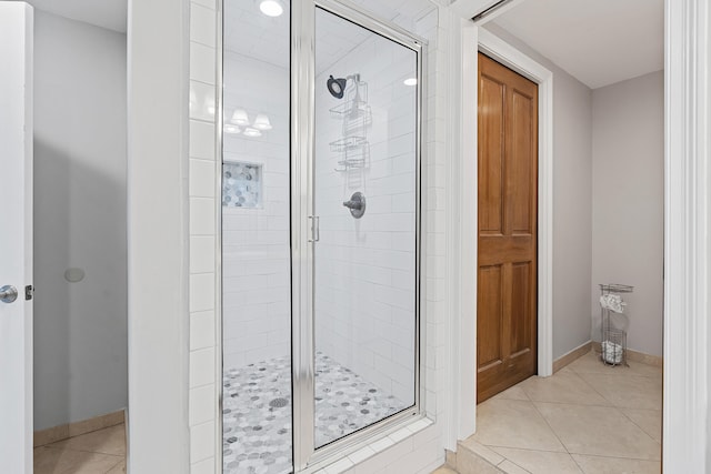 bathroom with tile patterned floors and a shower with shower door