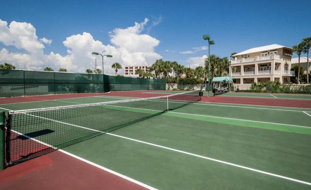 view of tennis court with basketball hoop