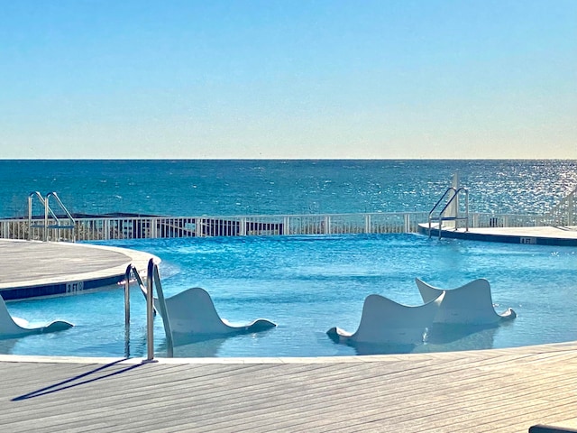 view of pool with a water view