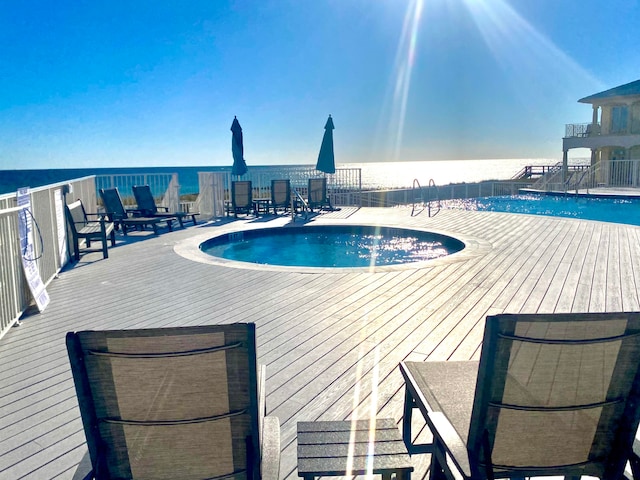 view of swimming pool with a water view