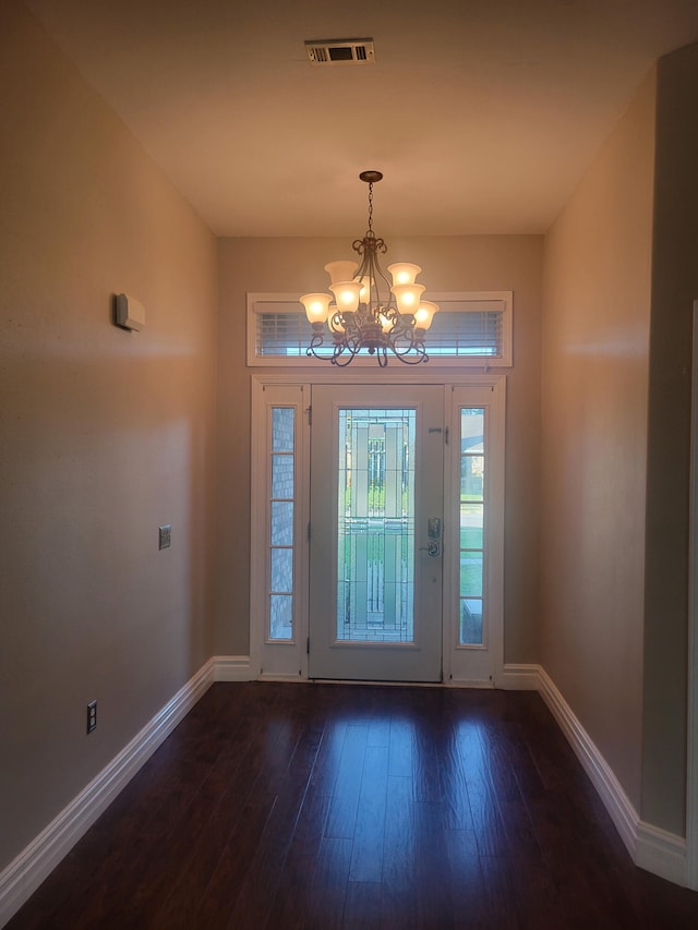 entrance foyer with a notable chandelier and wood-type flooring