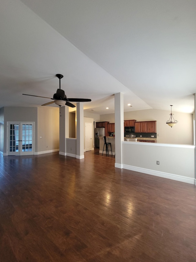 unfurnished living room featuring ceiling fan, dark wood-type flooring, and french doors