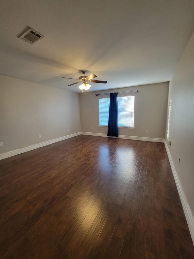 unfurnished room featuring ceiling fan and dark hardwood / wood-style flooring