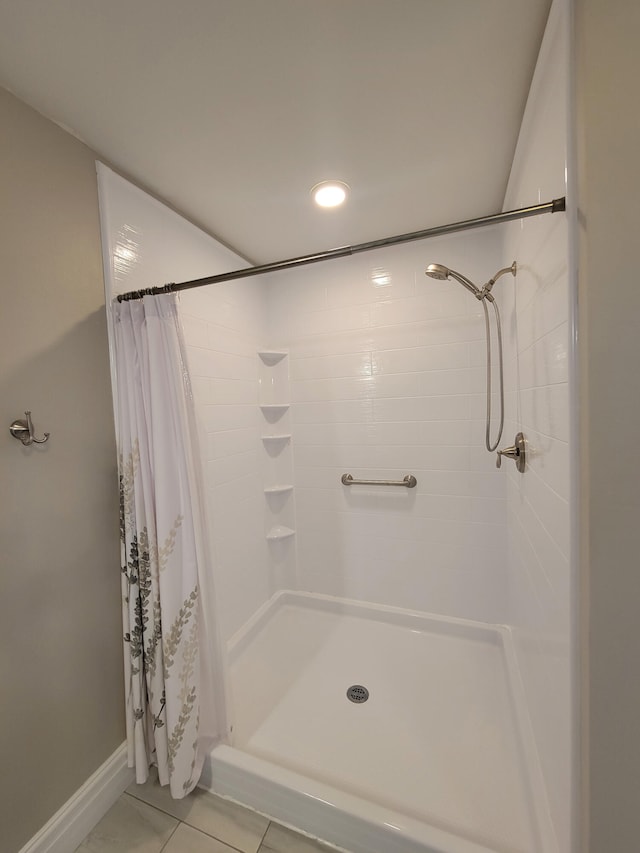 bathroom with tile patterned flooring and curtained shower