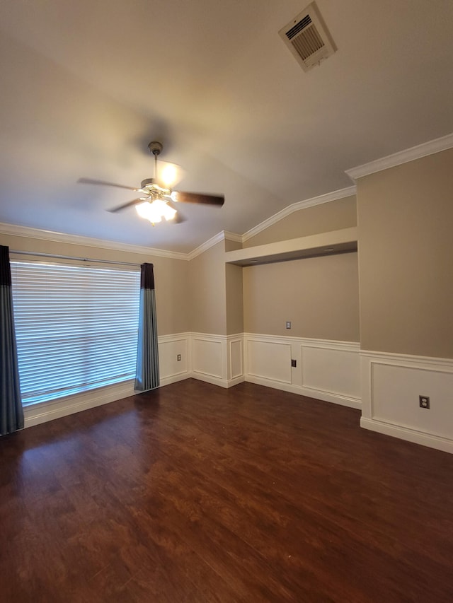 empty room with ceiling fan, dark hardwood / wood-style flooring, and crown molding