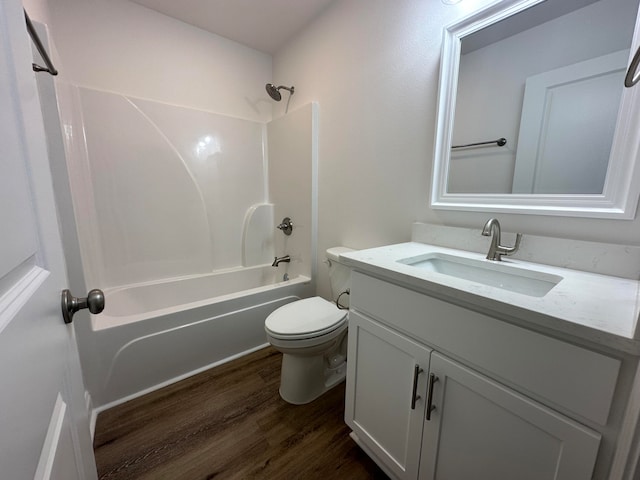 full bathroom featuring hardwood / wood-style flooring, vanity, toilet, and washtub / shower combination