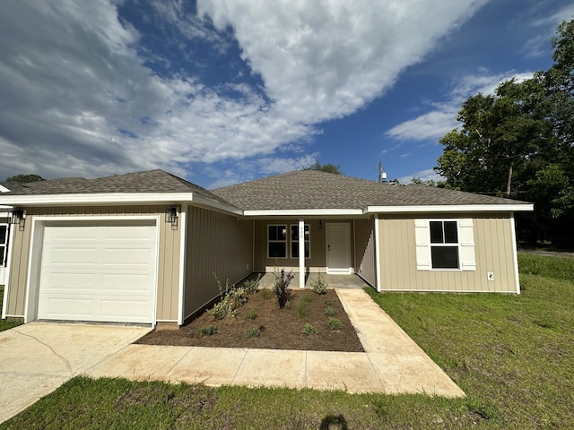 ranch-style house featuring a garage and a front yard