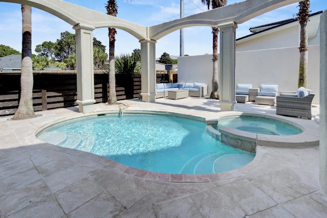 view of swimming pool featuring an in ground hot tub, a patio area, and an outdoor hangout area