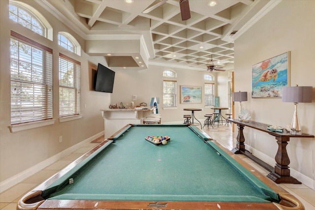 recreation room featuring ceiling fan, tile patterned flooring, crown molding, and coffered ceiling