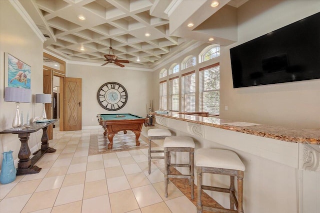 game room featuring light tile patterned floors, ornamental molding, a towering ceiling, and coffered ceiling